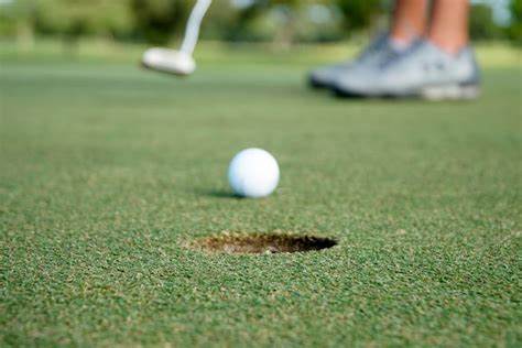 A golf ball close to the hole